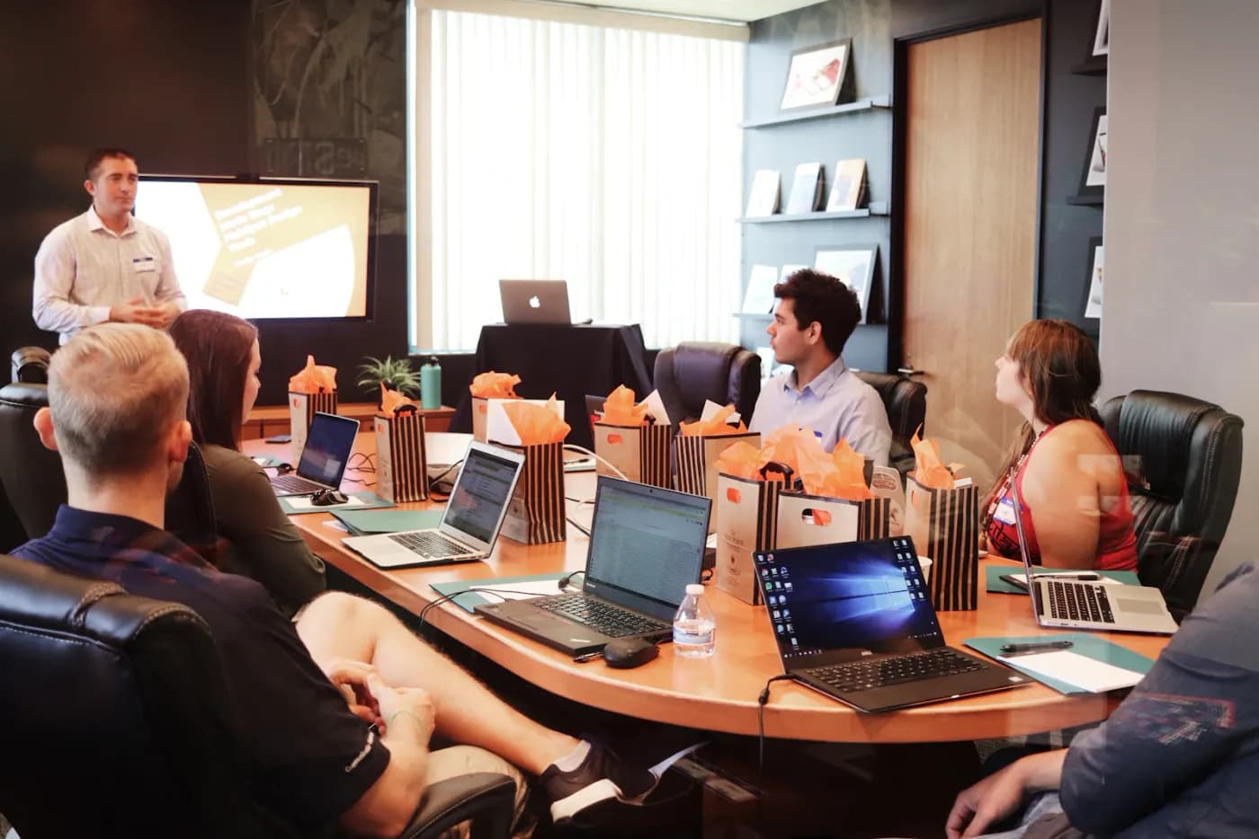 Compliance manager presenting posture dashboards to the team during a review meeting