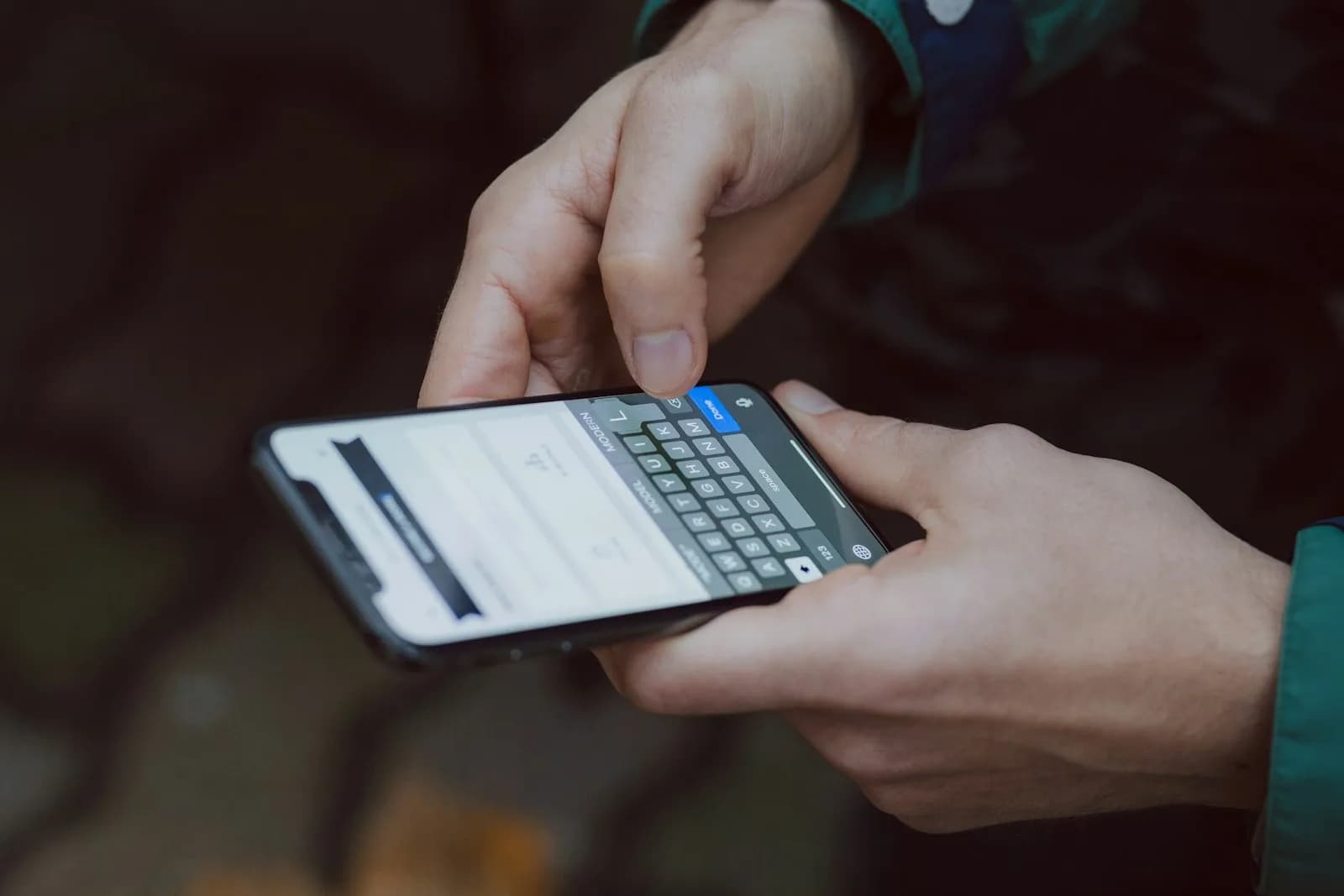 A hand entering information into a form on a smartphone, representing consent captured at the point of collection