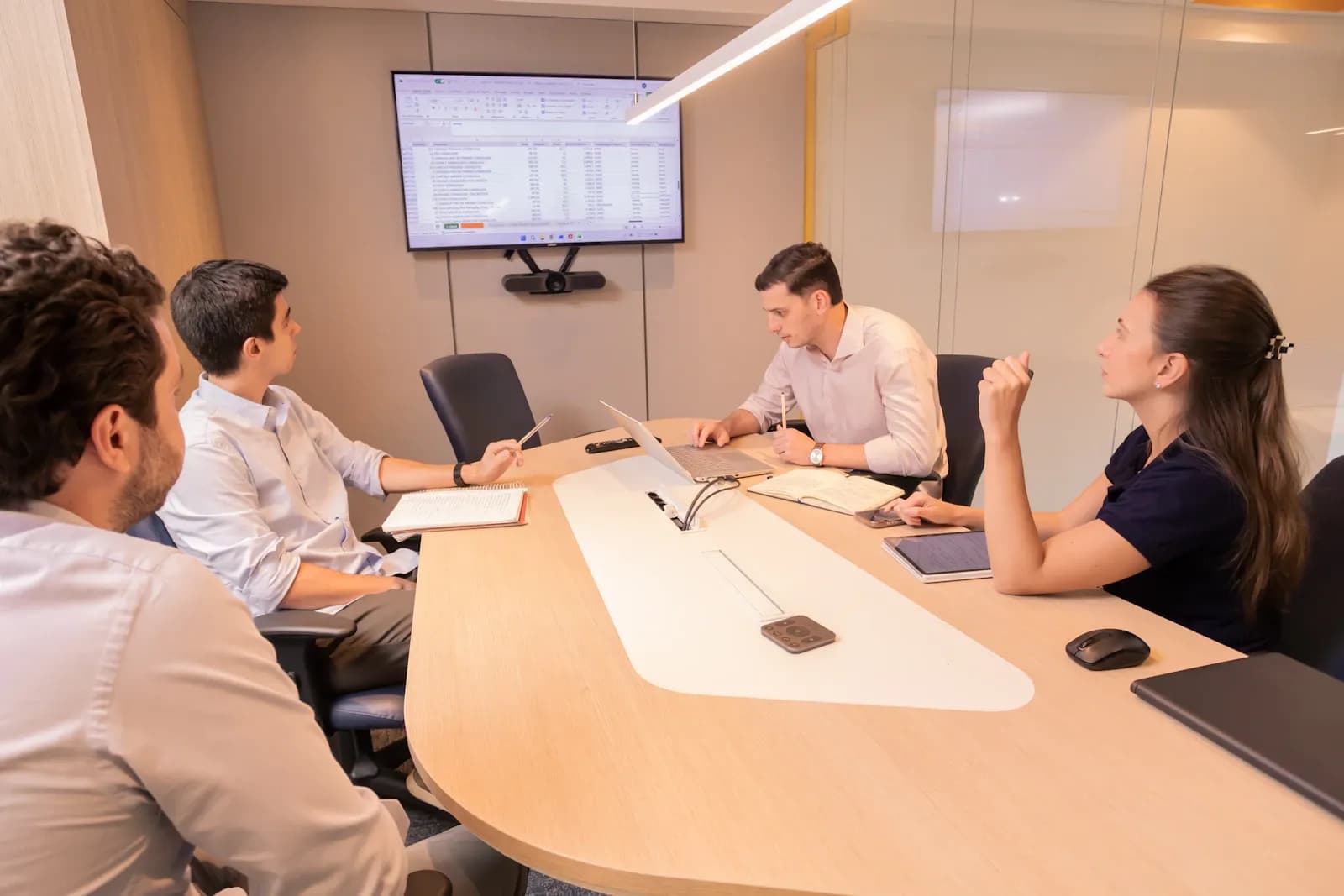 Analysts reviewing risk and financial impact data together in a meeting room